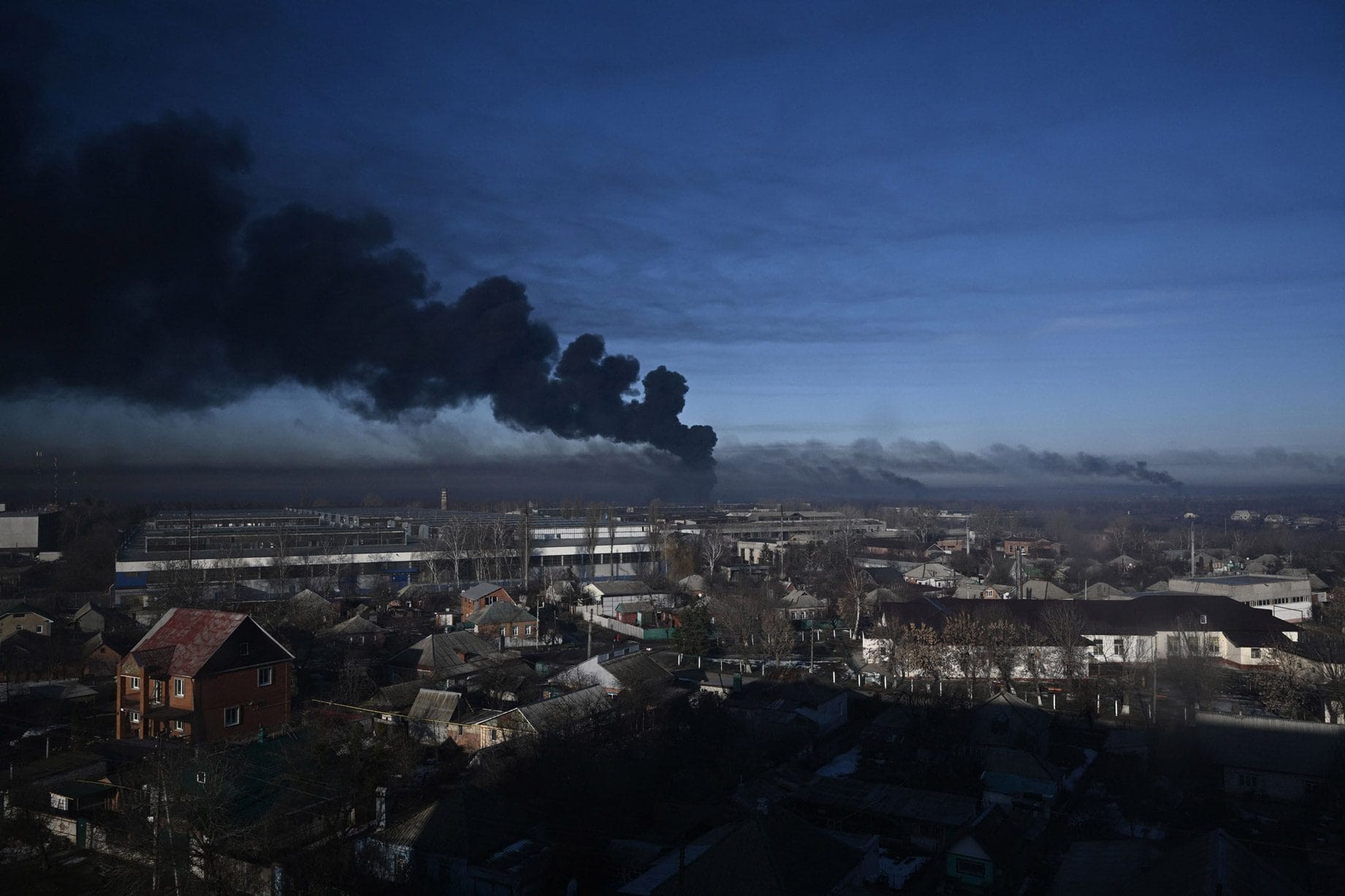 Black smoke rises from a military airfield in Chugoyev, near Kharkiv on February 24