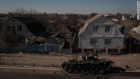 A destroyed tank sits in a street after battles between Ukrainian and Russian forces on a main road near Brovary, north of Kyiv, Ukraine, Thursday, March 10, 2022.