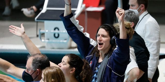 Leah Thomas of Pennsylvania cheers for her fellow competitors in the 1,650-yard freestyle final at Harvard, Saturday, February 19, 2022, in Cambridge, Massachusetts.