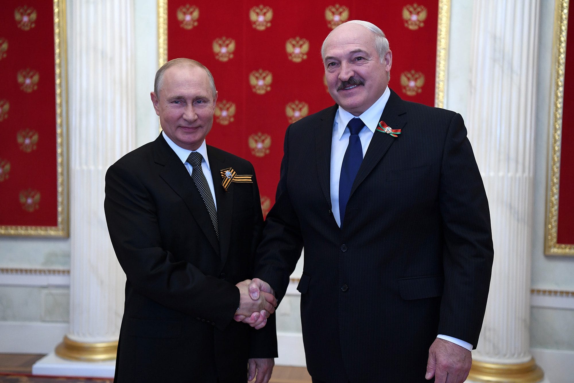Russian President Vladimir Putin (left) and Belarusian President Alexander Lukashenko shake hands while posing for a photo during a ceremony in the Kremlin, Moscow, Russia on June 24, 2020.